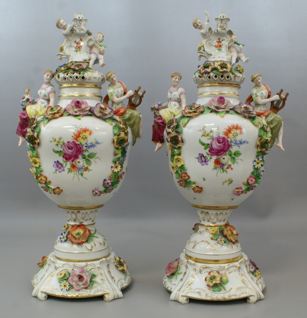 Appraisal: Pr Schierholz porcelain floral and cherub decorated covered jars high