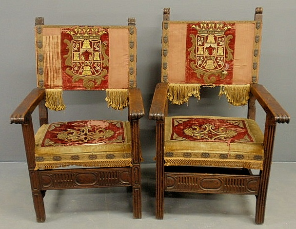 Appraisal: Two similar Jacobean walnut open armchairs with armorial crests and