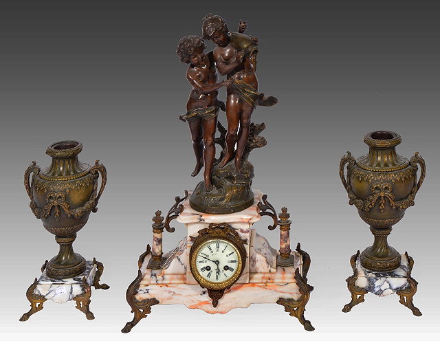 Appraisal: French marble clock garnitureSpelter figures and flanked by urns striking