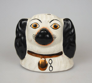 Appraisal: A money box in the form of a Staffordshire spaniel's