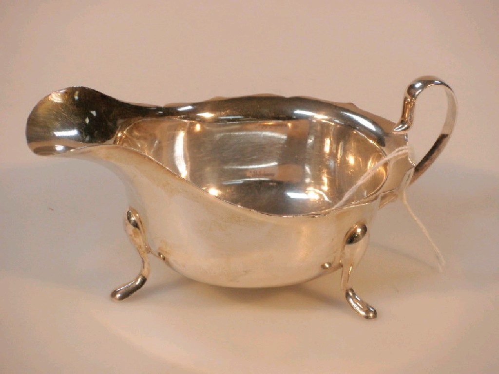 Appraisal: A modern silver sauce boat by Viners Sheffield with cut