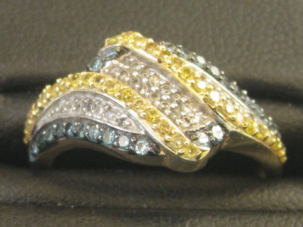 Appraisal: A white blue and yellow Diamond cross-over Dress Ring millegrain-set