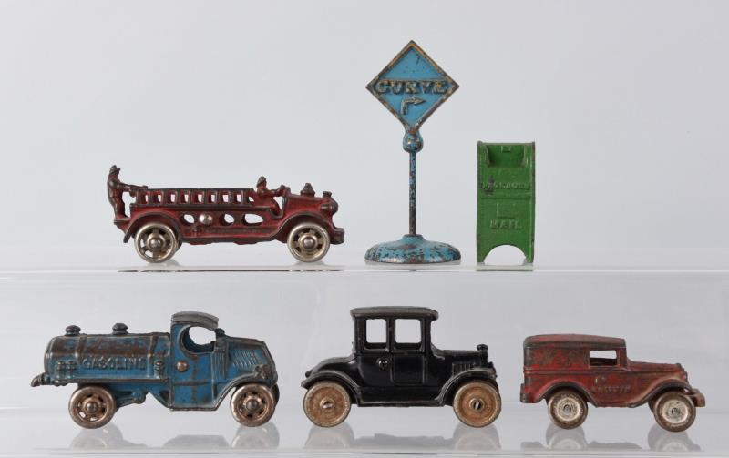 Appraisal: Lot of Cast Iron Toys Includes four trucks a curve