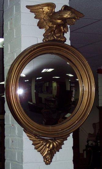 Appraisal: A circular convex wall mirror of Regency design the gilt