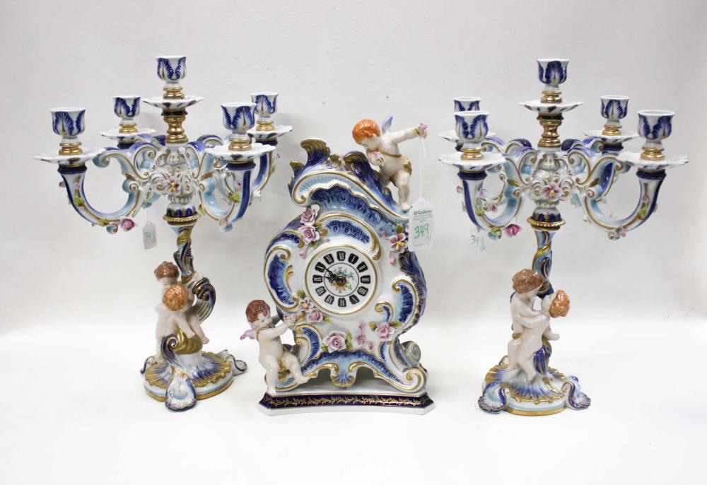 Appraisal: THREE PIECE PORCELAIN CLOCK SET the clock having putti figures