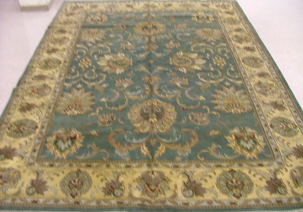 Appraisal: ORIENTAL INDO-PERSIAN CARPET floral design on green ground and ivory