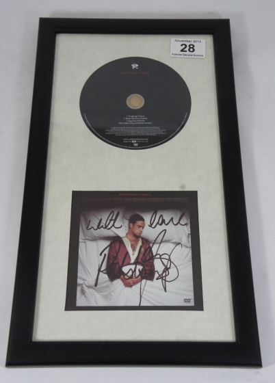 Appraisal: Robbie Williams signed plaque and album