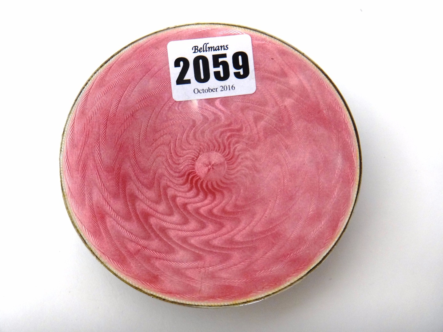 Appraisal: A silver and translucent pink enamelled circular dish raised on