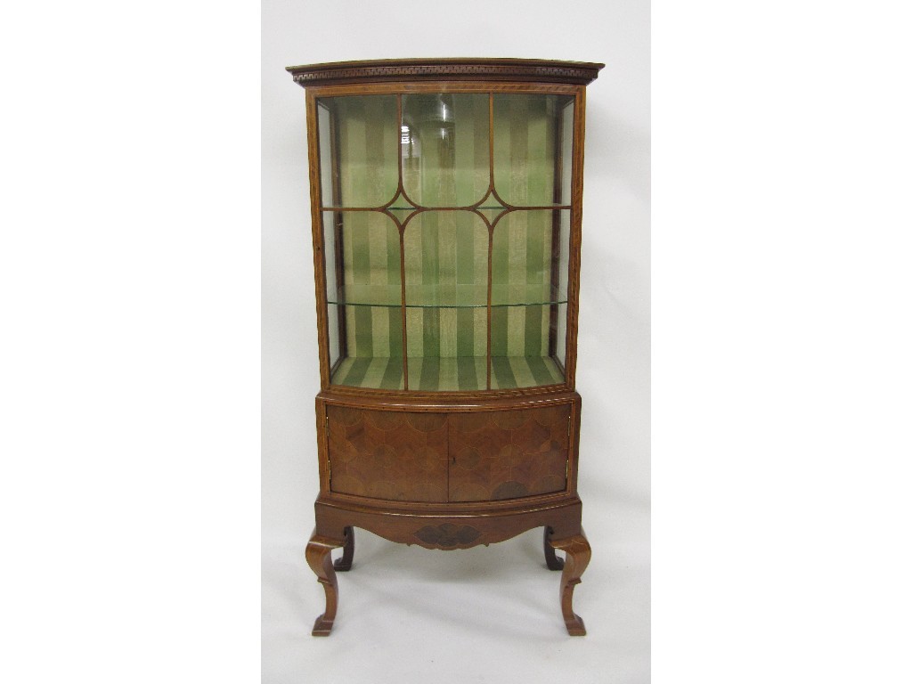 Appraisal: An Edwardian mahogany inlaid bow fronted display cabinet with a