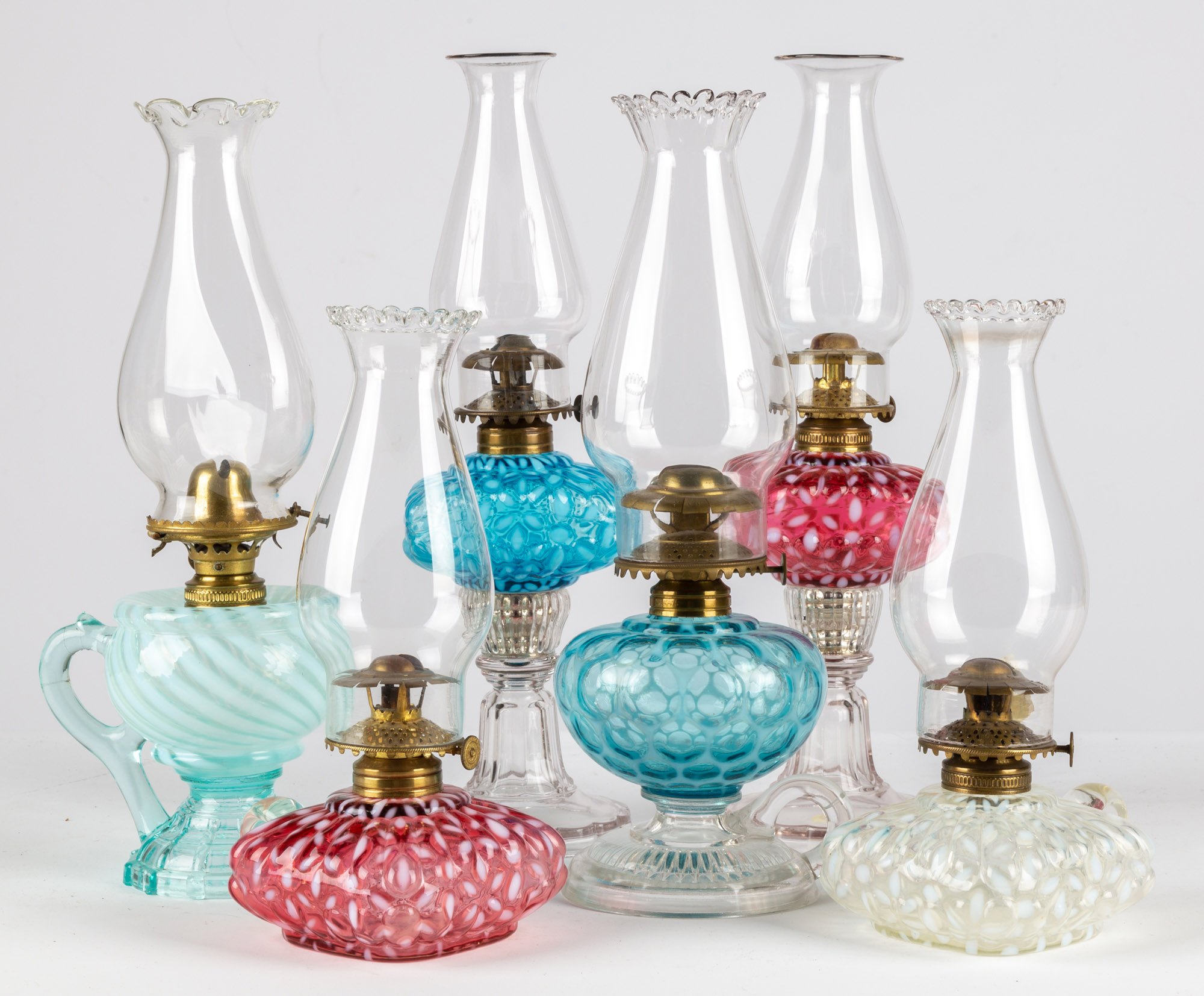 Appraisal: OPALESCENT GLASS FINGER OIL LAMPS circa period burners and shades