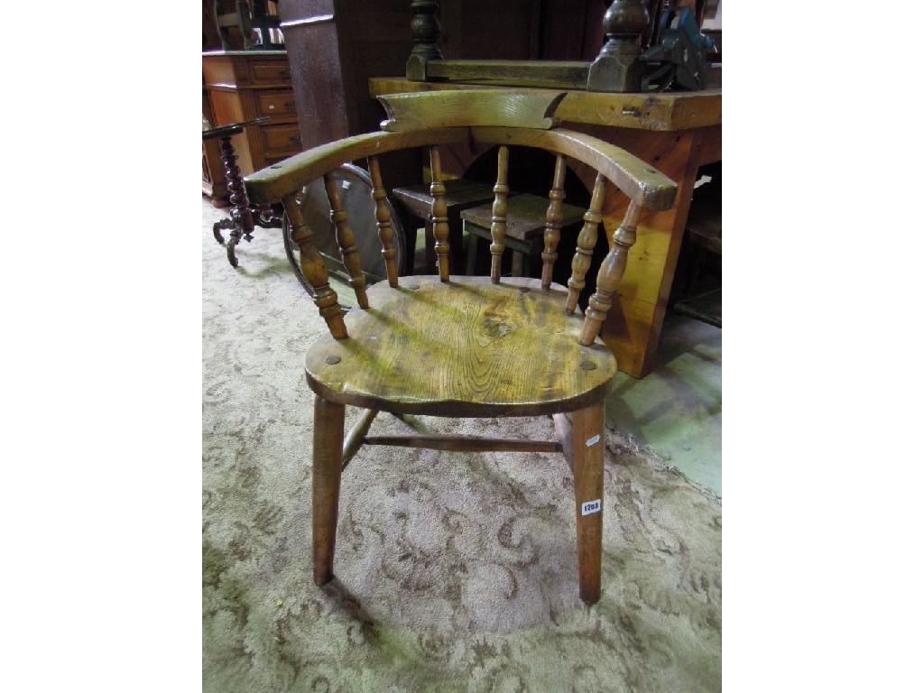 Appraisal: A Windsor elm and beech smokers elbow chair with turned