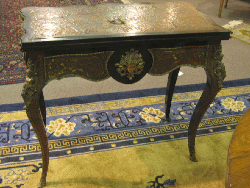 Appraisal: CONTINENTAL BOULLE AND ORMOLU GAMES TABLE Shaped and ormolu bound