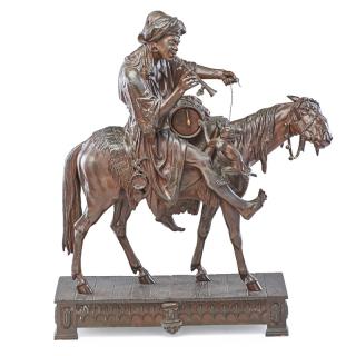 Appraisal: ORIENTIALIST PATINATED METAL SCULPTURE Orientalist figure on horseback with a