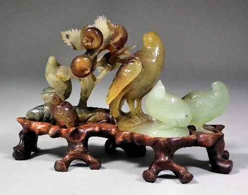 Appraisal: A Chinese hardstone carving of birds amongst trees on hardwood