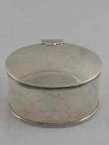 Appraisal: An oval silver tea caddy the lid with fitted spoon