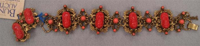 Appraisal: Linked bracelet featuring coral colored carved women's faces with matching