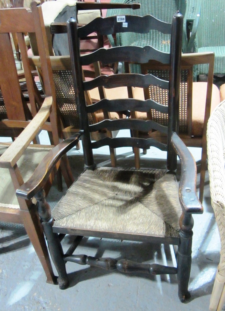 Appraisal: A th century ash ladder back armchair with rush seat