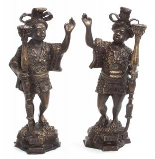 Appraisal: A Pair of Bronze Figural Candlesticks A Pair of Bronze