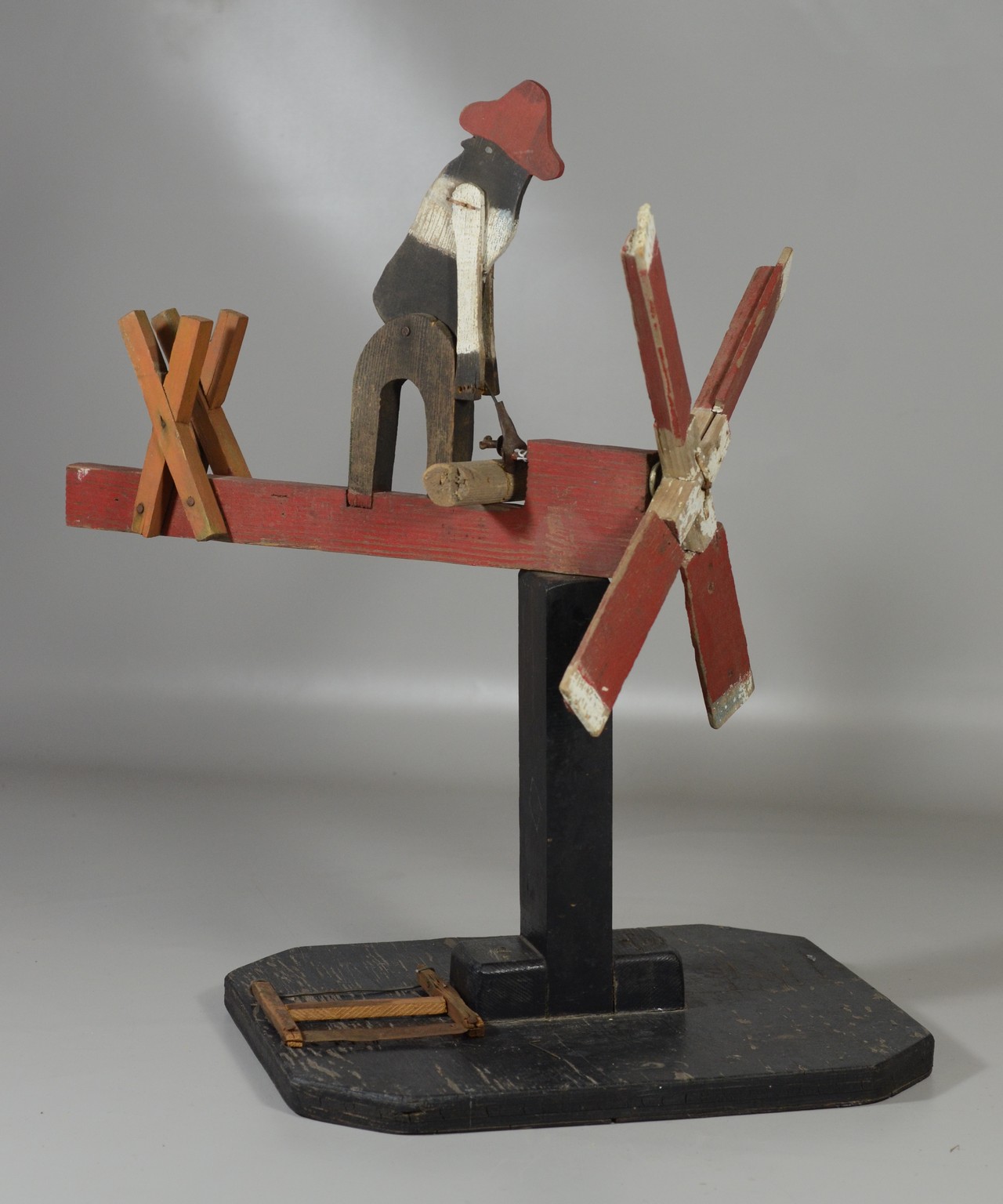 Appraisal: American folk art whirligig with woodcutter on wooden base wide