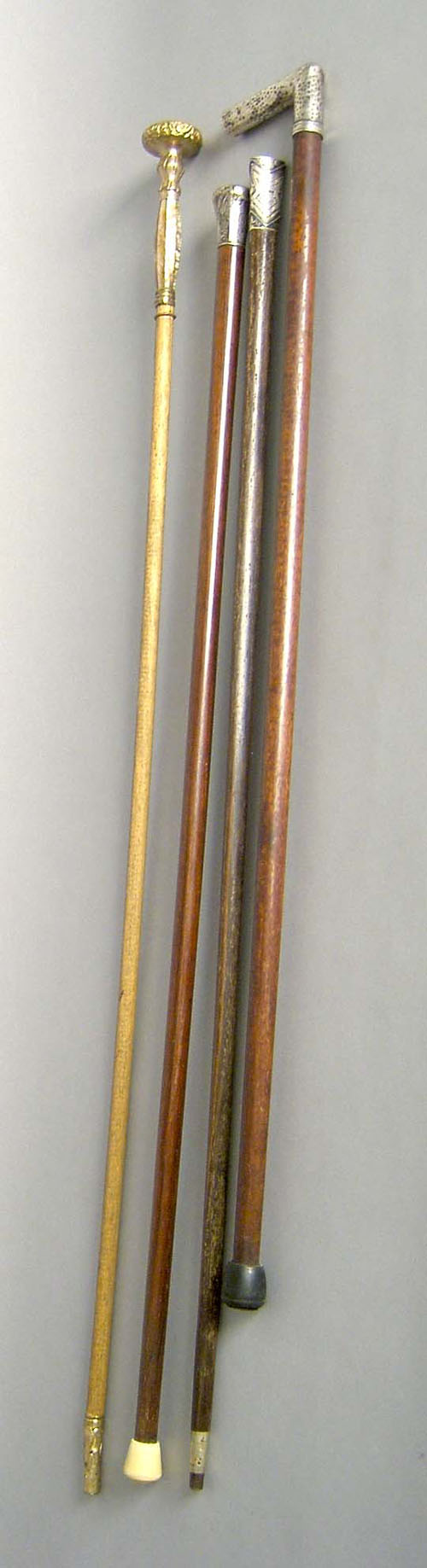 Appraisal: Three silver tip canes together with a gold tip cane