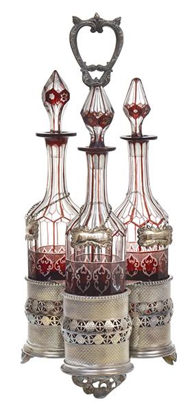 Appraisal: A SILVER PLATE TANTALUS WITH THREE RED FLASHED DECANTERS cm