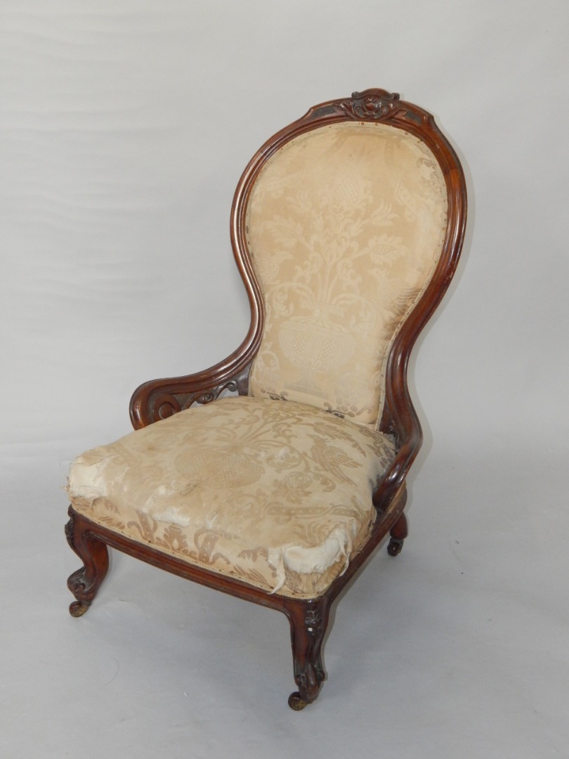 Appraisal: A Victorian walnut balloon back nursing chair with overstuffed seat