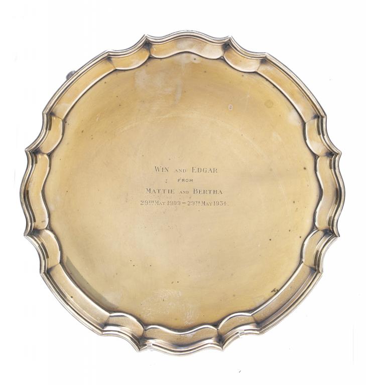 Appraisal: A GEORGE V SALVER with moulded border on four volute