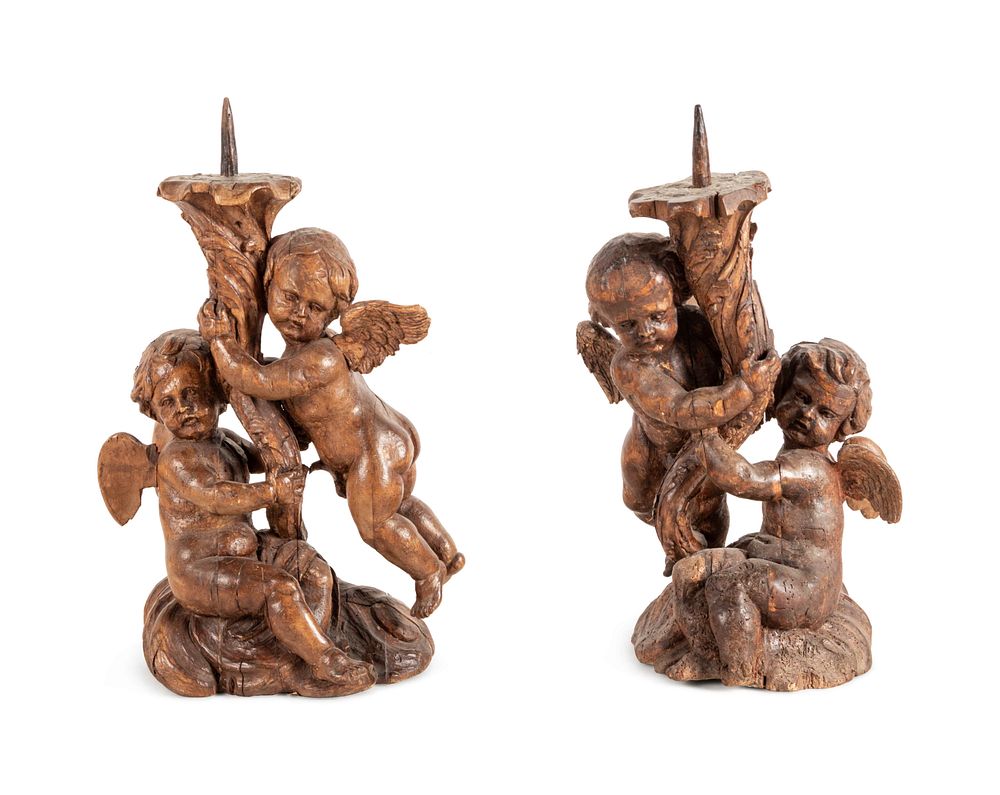 Appraisal: A Pair of Continental Carved Wood Cherubic Prickets A Pair