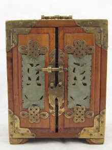 Appraisal: A brass mounted three drawer Chinese cabinet set with carved