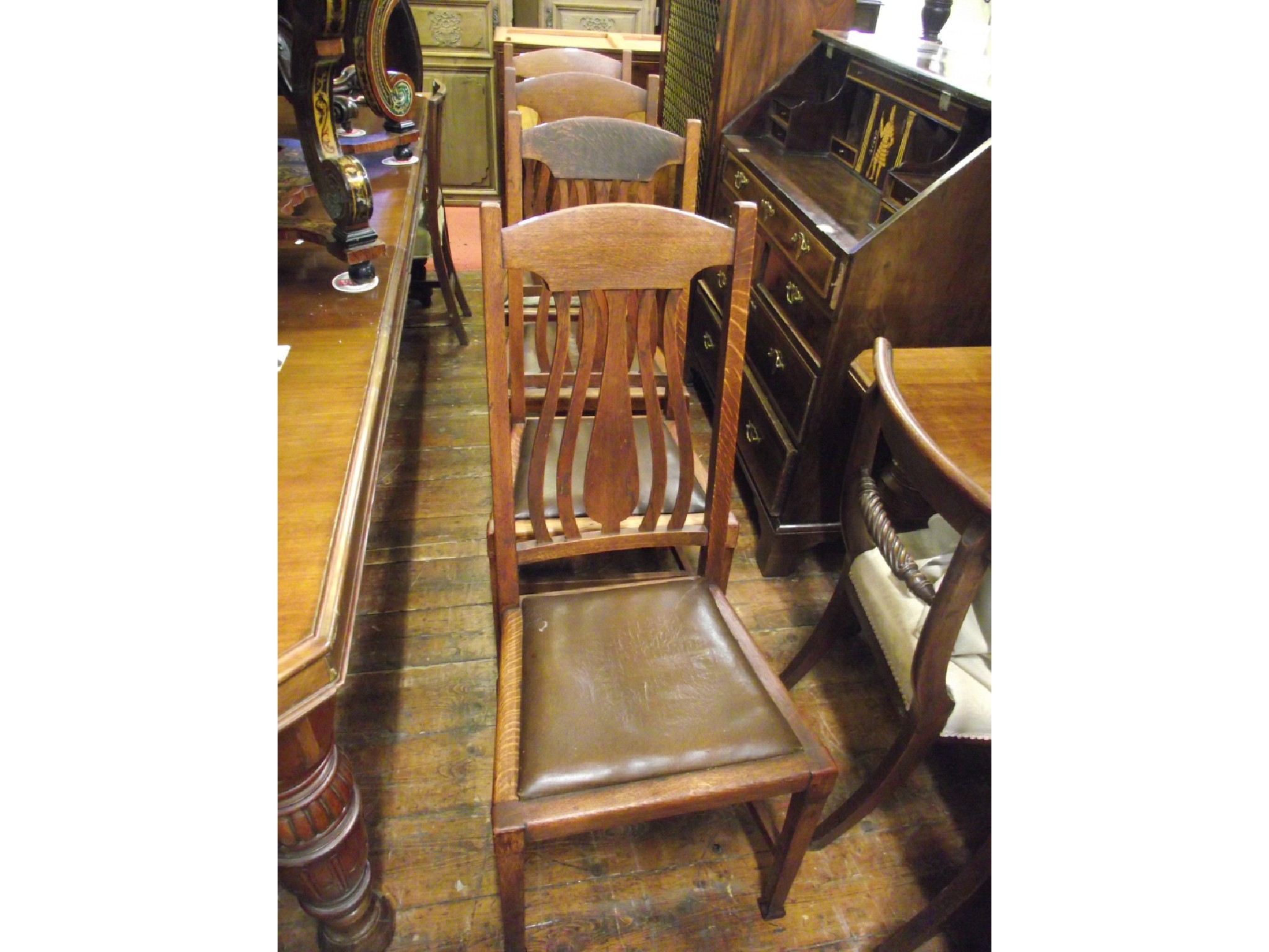 Appraisal: A set of four Arts Crafts oak dining chairs with