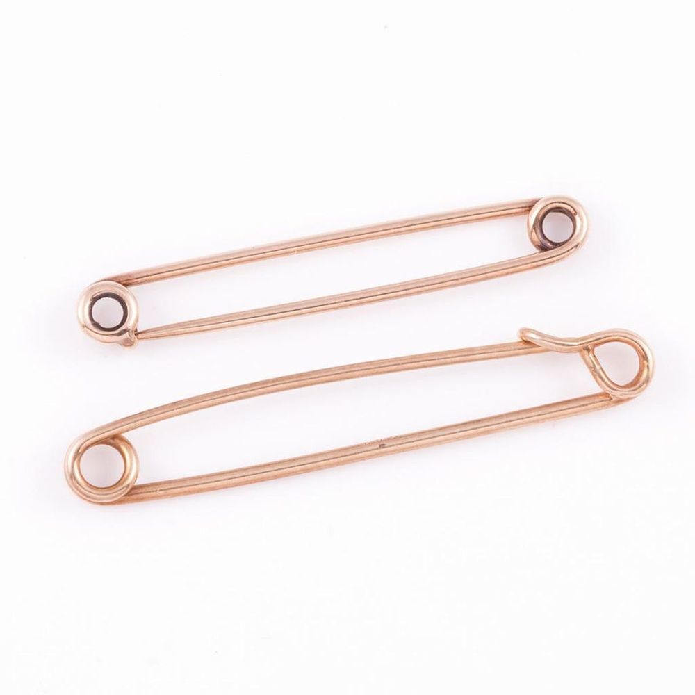 Appraisal: Two k gold safety pins Tiffany Co and Krementz gross