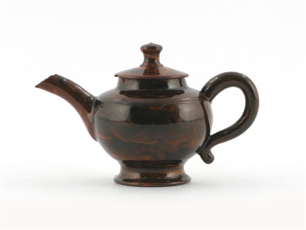 Appraisal: A miniature agateware teapot and cover