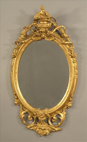 Appraisal: A Victorian gilt oval wall mirror circa with pierced ribbon