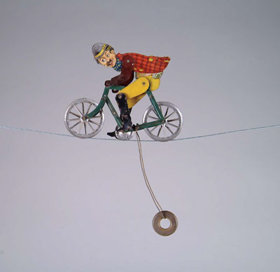 Appraisal: TIN FIGURAL CHARLIE CHAPLIN STRING RIDER Flat tin colorful lithographed