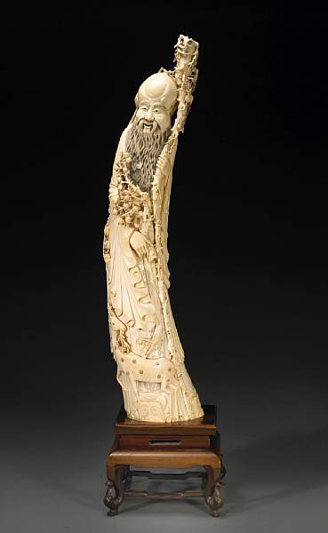 Appraisal: A tinted ivory standing figure of Shoulao th Century The