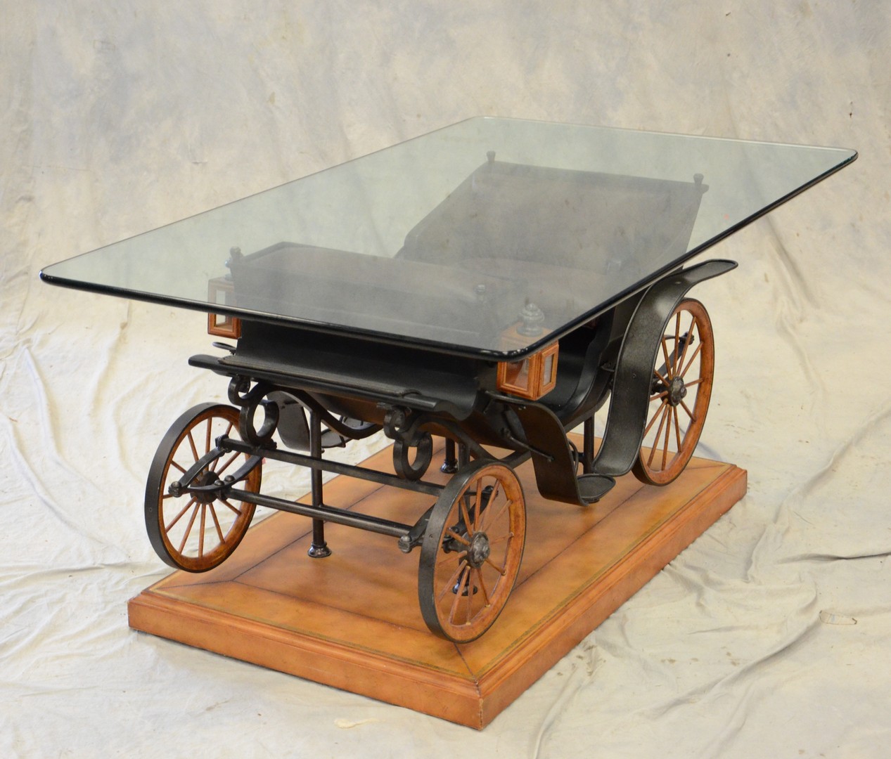 Appraisal: Horse drawn carriage with glass top coffee table leather covered