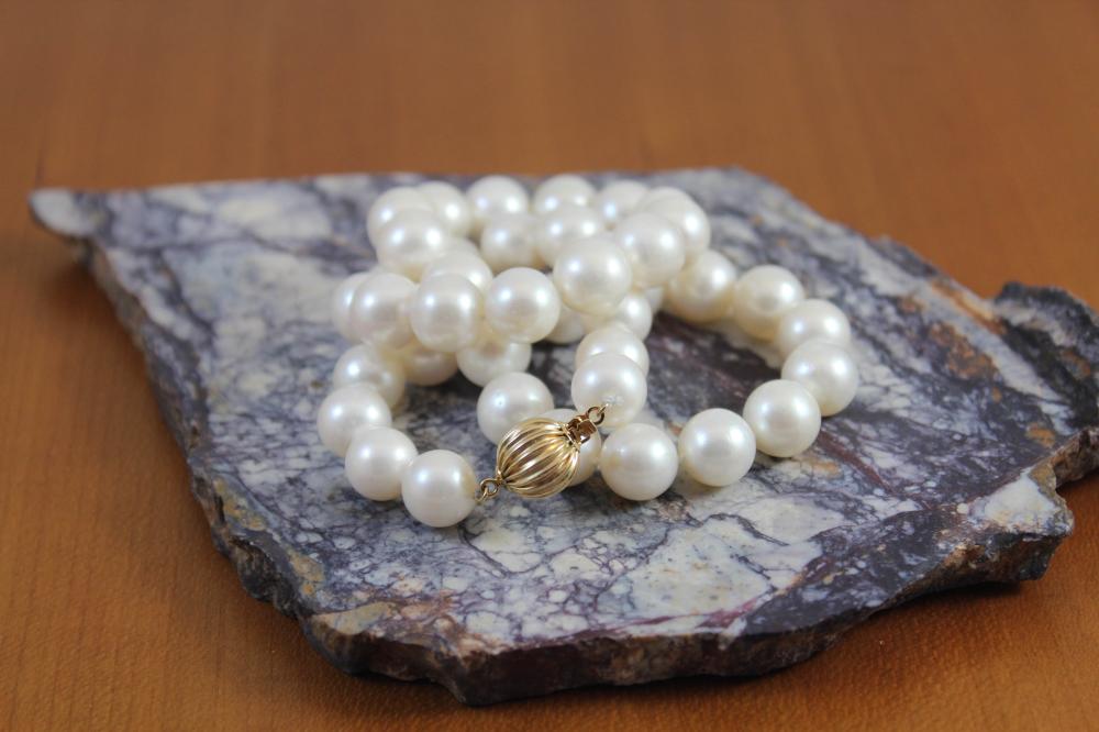 Appraisal: PRINCESS LENGTH PEARL AND FOURTEEN KARAT GOLD NECKLACE - hand-knotted