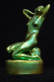 Appraisal: A Zsolnay green metallic luster glazed figure of a kneeling