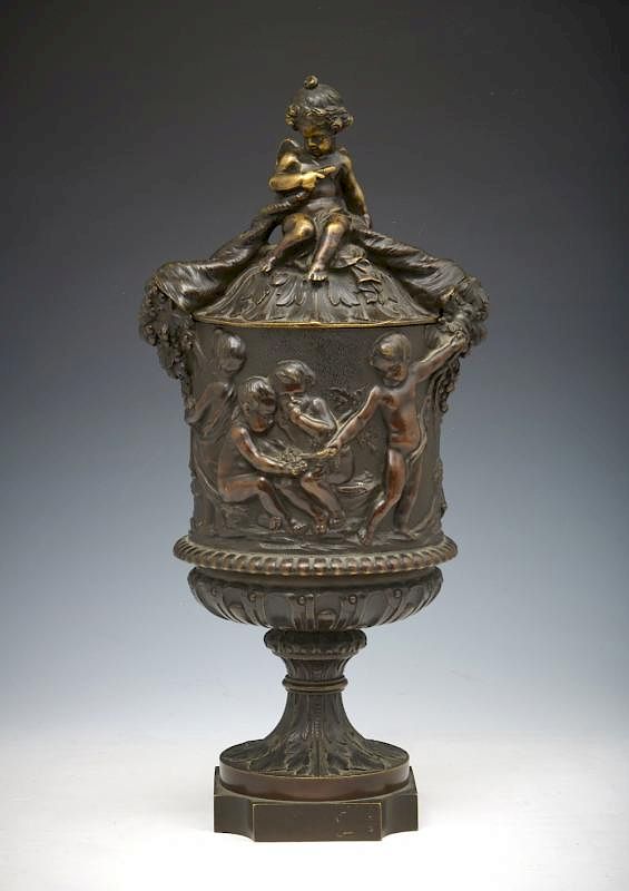 Appraisal: Bronze lidded urn decorated with cupid cornucopias h Bronze lidded