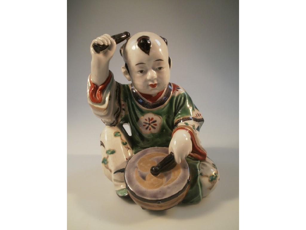 Appraisal: A Chinese poly-chrome enamelled figure of a drummer boy cm