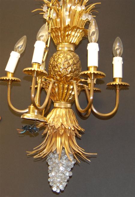 Appraisal: A pair of giltmetal chandeliers the central section shaped as