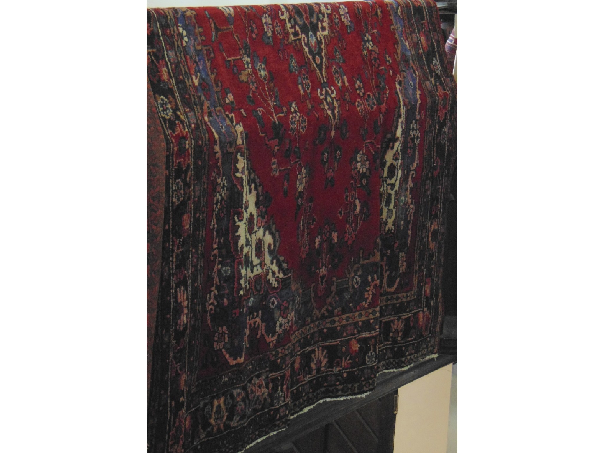 Appraisal: A substantial eastern wool carpet with deep red field set