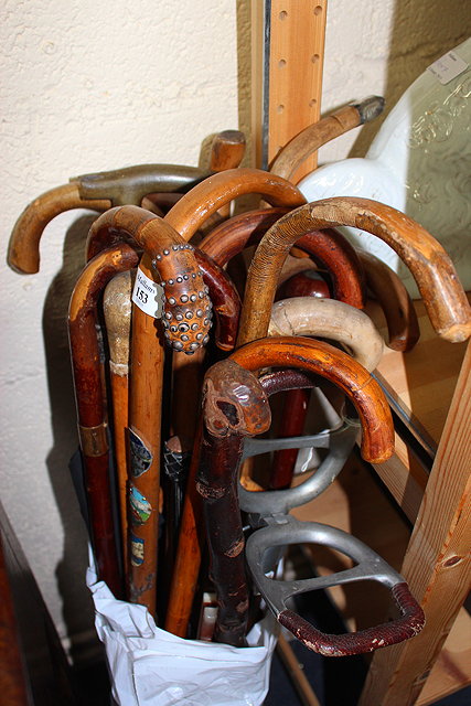 Appraisal: A GROUP OF VARIOUS WALKING STICKS and parasols