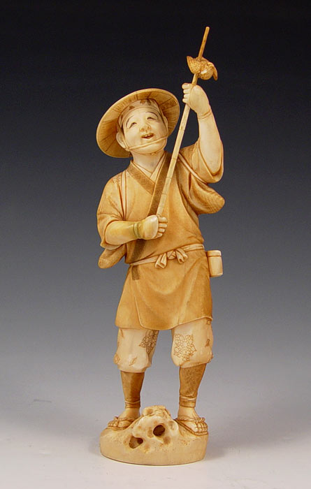 Appraisal: CARVED IVORY FIGURE Man with bird signed '' high