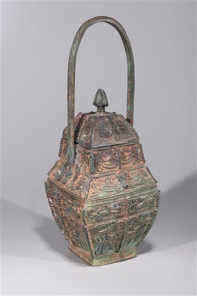 Appraisal: Chinese archaistic bronze covered vase with large handle elaborate designs