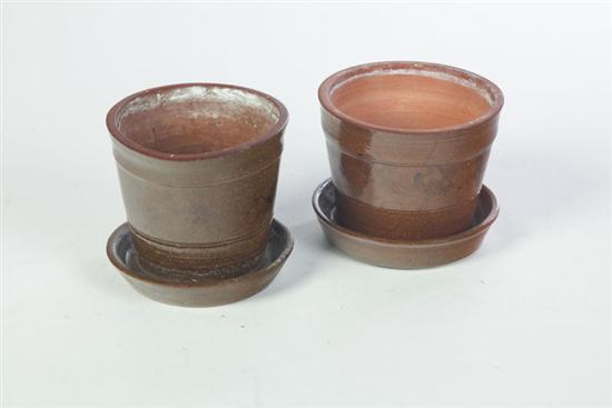 Appraisal: TWO REDWARE FLOWER POTS American Similar with attached undertrays The