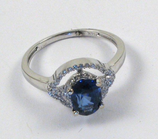 Appraisal: SAPPHIRE AND FOURTEEN KARAT GOLD RING pave' set diamonds surround