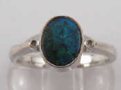 Appraisal: An carat white gold opal ring with diamond accents opal