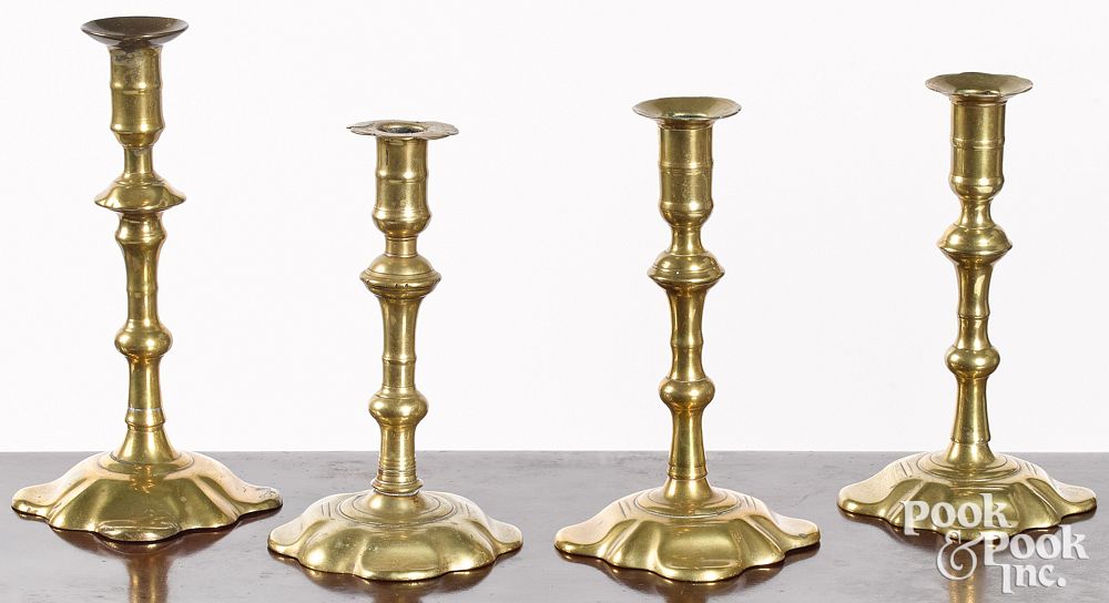 Appraisal: Four Queen Anne petal base candlesticks Four Queen Anne petal