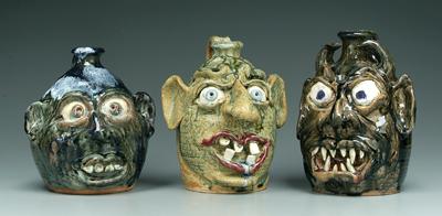 Appraisal: Three Flowers face jugs all with exaggerated features pointed and